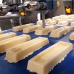 Dough bars on the conveyor belt approaching the dosing system (Source: ViscoTec)
